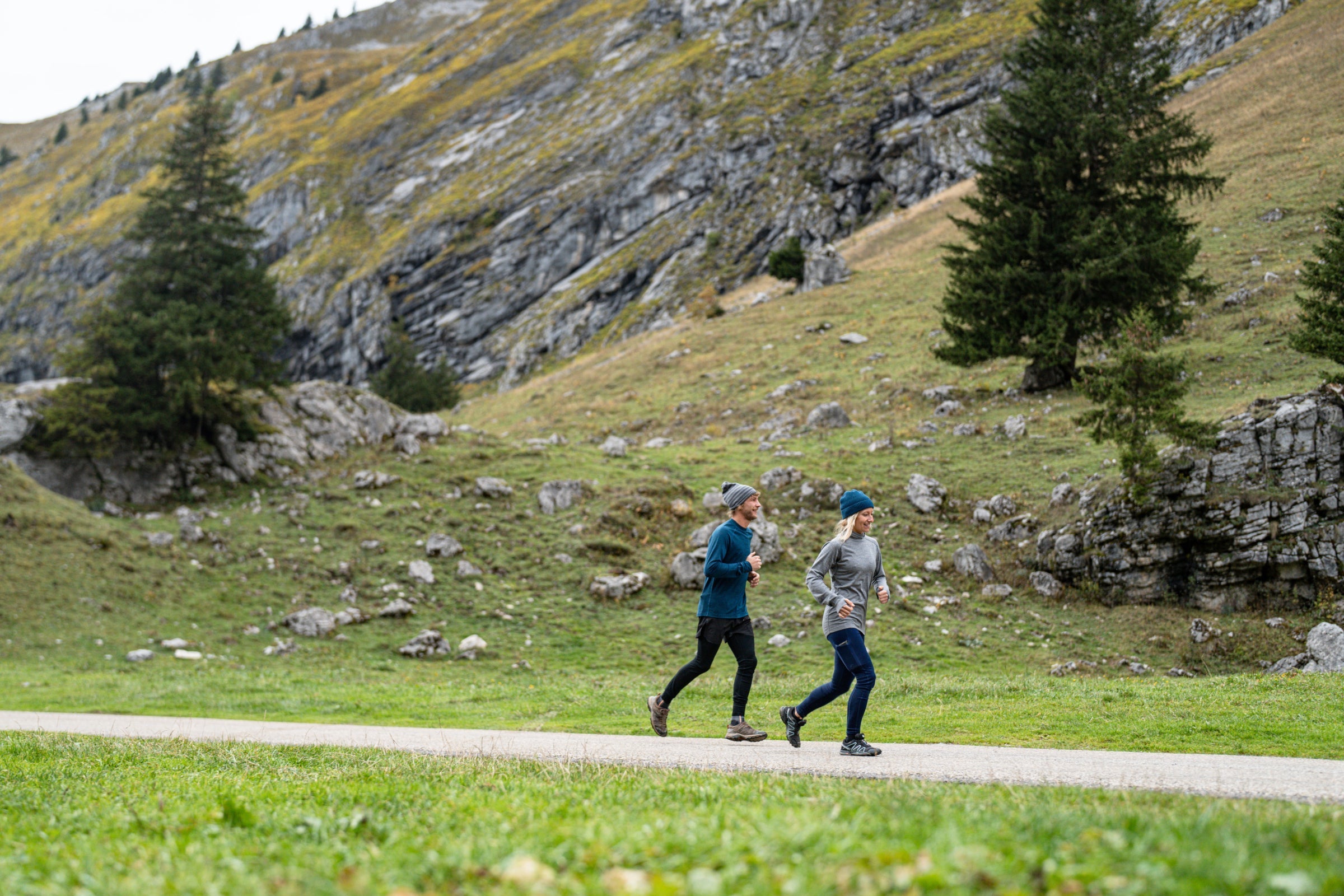 Two runners in Isobaa merino activewear on a scenic mountain path