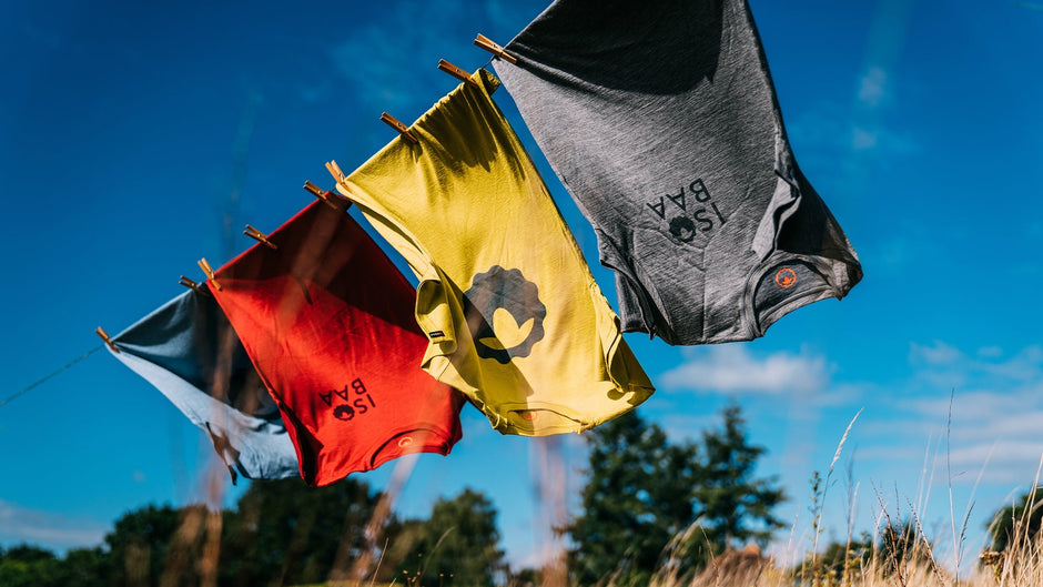 Isobaa Merino Emblem & Graphic Tees hanging on a clothes line on a sunny day