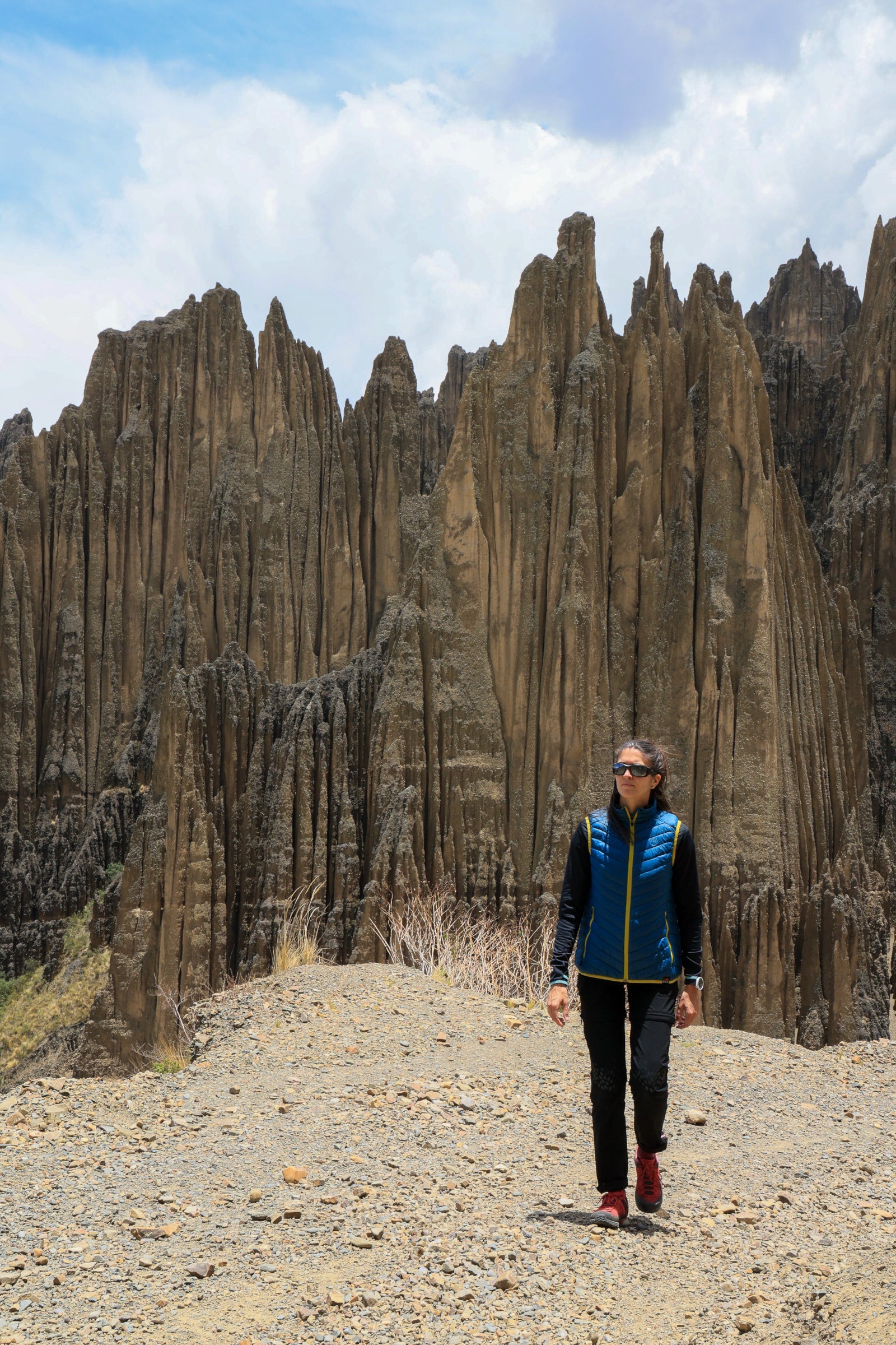 Tiphaine in a rocky valley – Walking past dramatic cliffs.