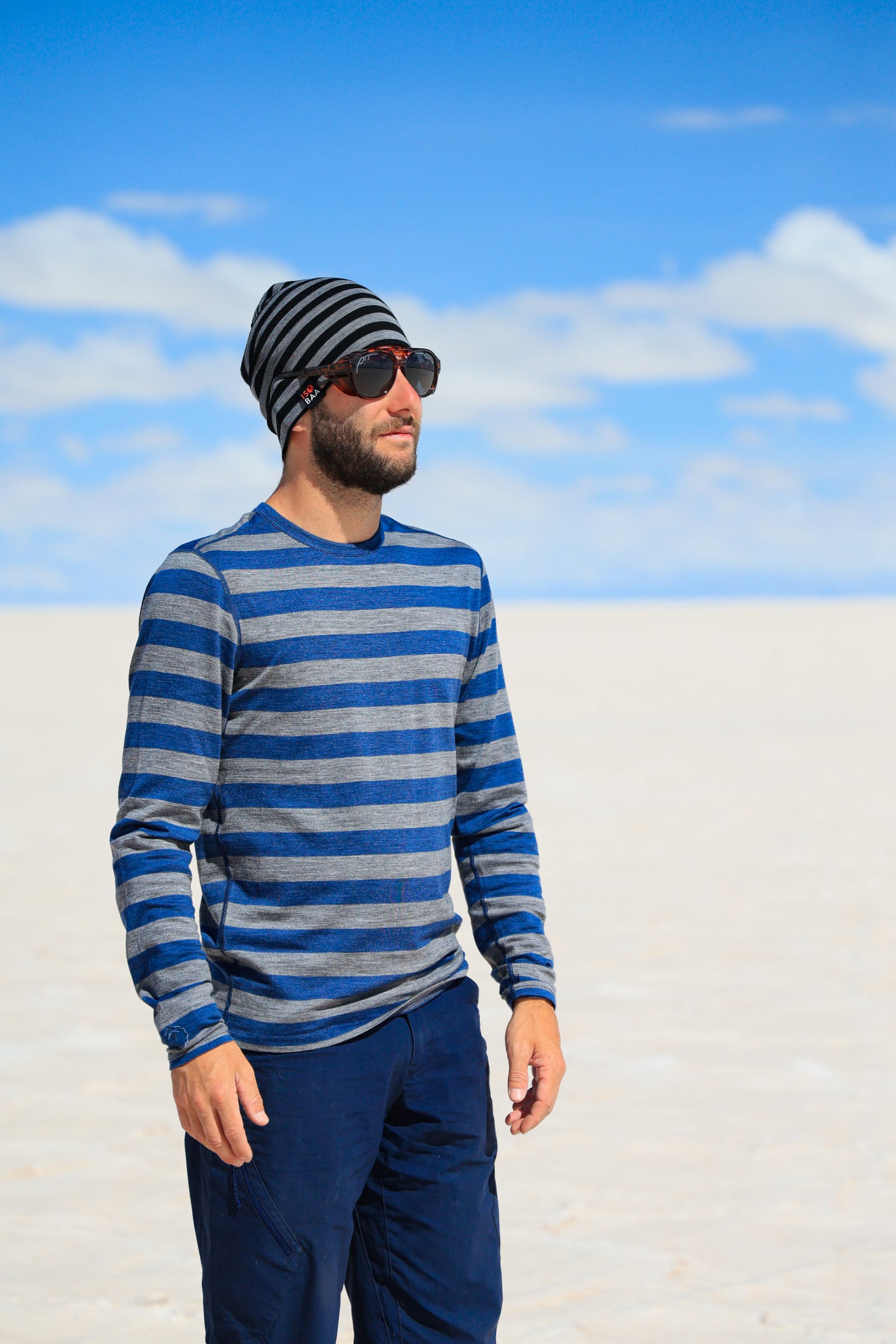 Baptiste in a salt flat – Standing under a vast blue sky.