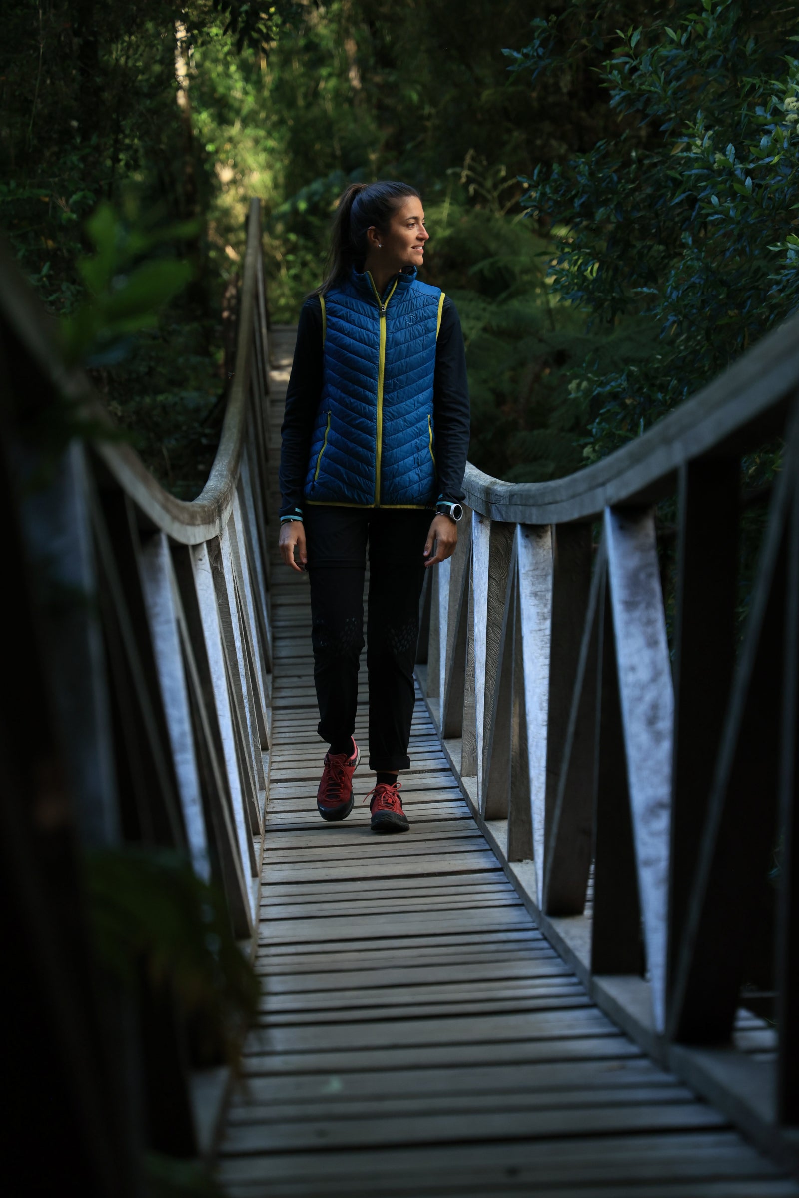 Tiphaine on a wooden bridge – Walking through a lush forest